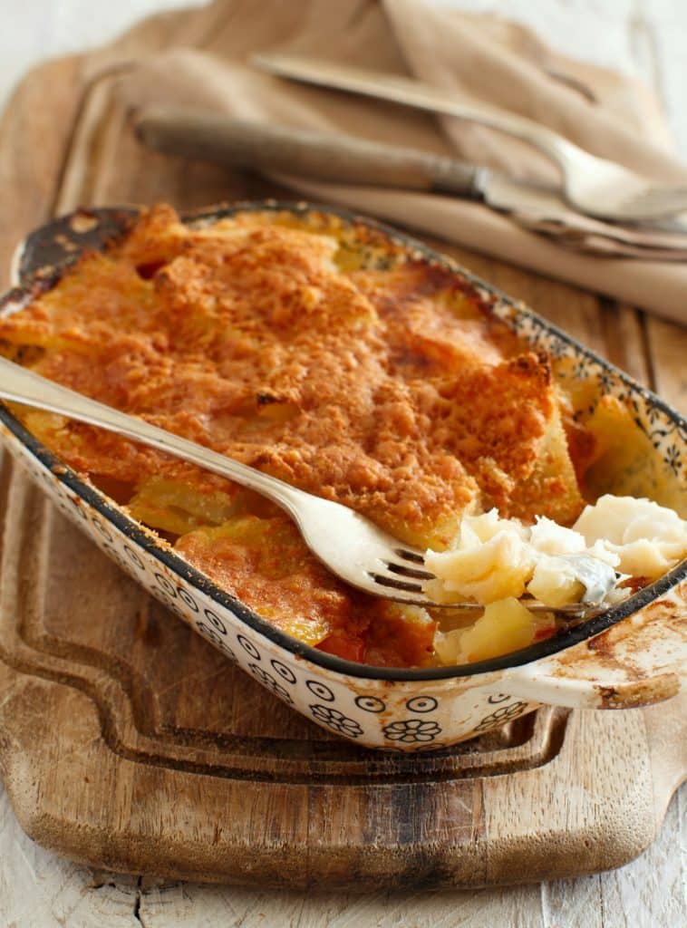 Codfish with potatoes cooked in the oven close up